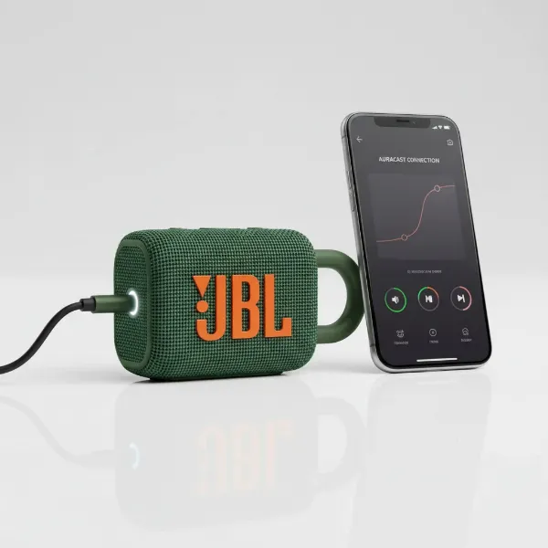 The JBL Go 4 speaker with a USB-C cable, next to a smartphone displaying the JBL Portable app interface.