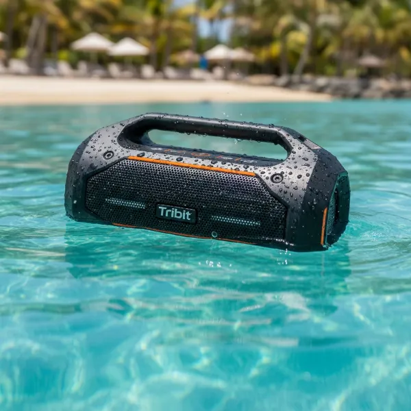 Tribit StormBox Blast portable speaker submerged partially in water, demonstrating its IPX7 waterproof rating.